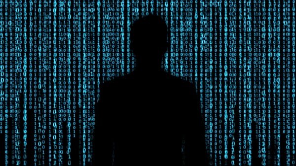 Shadow of person against background of binary code.